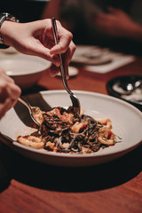 Black spaghetti. Black seafood pasta with mussels over black background. Mediterranean delicacy food