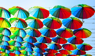 Fototapeta na wymiar many colored umbrellas in the sky. Multicolored background. Umbrella. Weather 