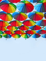 many colored umbrellas in the sky. Multicolored background. Umbrella. Weather