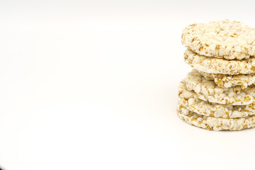 Grain crispbreads on white background. Puffed whole grain crispbread. Dieting Eating Concept. Copy space