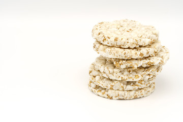 Grain crispbreads on white background. Puffed whole grain crispbread. Dieting Eating Concept. Copy space