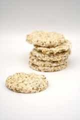 Grain crispbreads on white background. Puffed whole grain crispbread. Dieting Eating Concept. Copy space