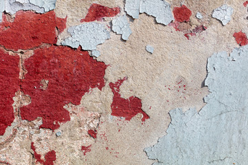 Concrete wall with cracked paint as abstract background