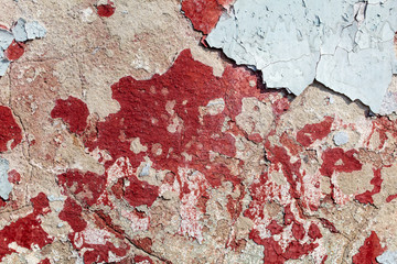 Concrete wall with cracked paint as abstract background