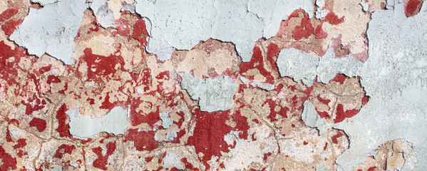Concrete wall with cracked paint as abstract background