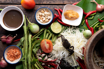 Som Tam Thai - Papaya Salad Thai Food Style on wooden table background. Thai Food Concept. Top View
