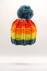 Colorful winter knitted hat on a white background.