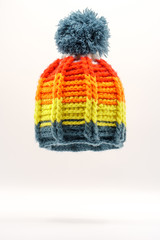 Colorful winter knitted hat on a white background.