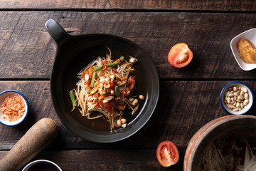 Som Tam Thai - Papaya Salad Thai Food Style on wooden tabal background. Thai Food Concept. Top View