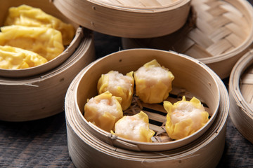 Dim sum on wooden table. Chinese food concept.