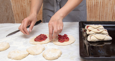 The hostess prepares the pies in the kitchen