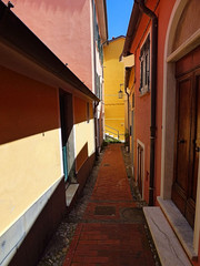 Fototapeta na wymiar Narrow brightly colored street in Telaro, Italy a seaside town on the Italian Riveria.