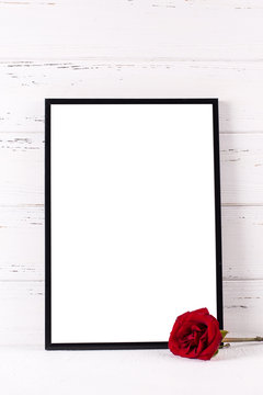 Black frame mockup and red rose flower