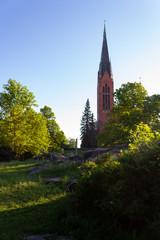 View of the Lutheran Church of St. Michael's historic landmark in the city of Turku in Finland in the rays of the setting sun.