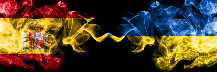 Spain vs Ukraine, Ukrainian smoky mystic flags placed side by side. Thick colored silky smokes flag of Spanish and Ukraine, Ukrainian