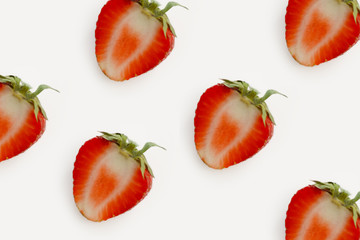 half red strawberry lot on light background closeup