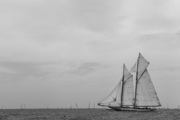Vintage yachts race in Barcelona. Old ships and boats in the sea. Black and white photos of...
