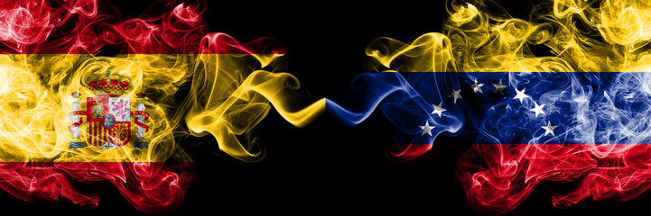 Spain vs Venezuela, Venezuelan smoky mystic flags placed side by side. Thick colored silky smokes flag of Spanish and Venezuela, Venezuelan
