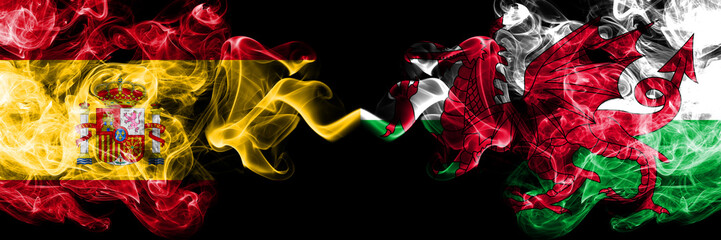 Spain vs Wales, Welsh smoky mystic flags placed side by side. Thick colored silky smokes flag of Spanish and Wales, Welsh