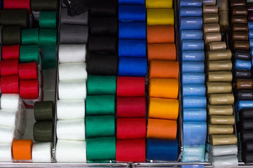 roll tape and braid of different colors on the shelf in the store