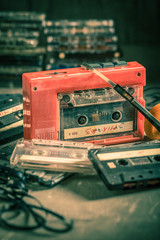Closeup of antique audio cassette with walkman and headphones
