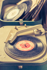 Closeup of vintage record player and old vinyls with scratched