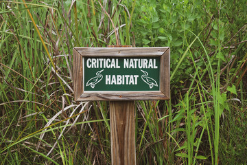 Wildlife Critical Natural Habitat Sign In Tall Grass