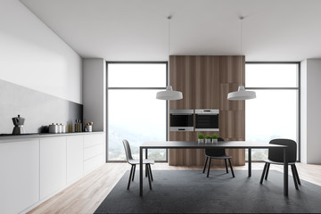 Loft white and wooden kitchen with table