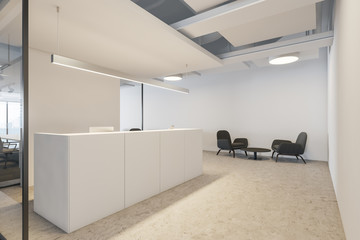 White reception desk and lounge area