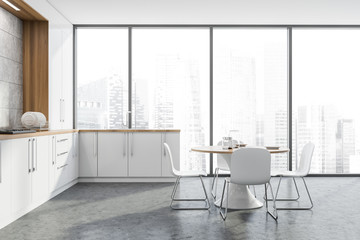 Panoramic white kitchen with counters and table