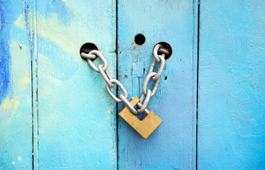 An old lock holds ancient door handles