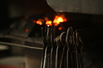 The blacksmith works with incandescent iron