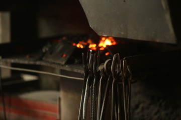 The blacksmith works with incandescent iron