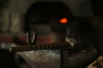 The blacksmith works with incandescent iron