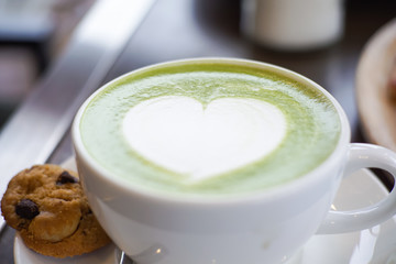 Matcha Green Tea Latte Close up with Cookies on table