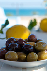 Italian green and black olives in olive oil close up