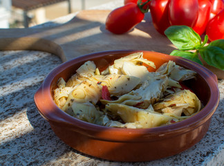 Italian food, marinated artichokes hearts with herbs and garlic