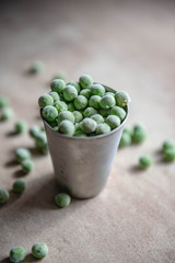 Small bucket with frozen young green peas