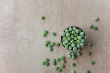 Fototapeta na wymiar Small bucket with frozen young green peas