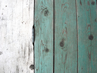 Background of boards. The texture of a wooden fence with a door hinge.   