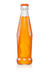 Orange carbonated soft drink in glass bottle isolated