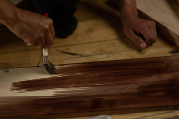 A man paints wooden steps