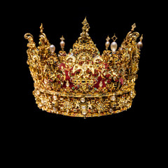 Golden crown with gems isolated on black background