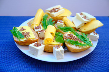 Fresh bread with cheese and basil for breakfast in a trip