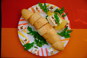 Fresh bread with cheese and basil for breakfast in a trip