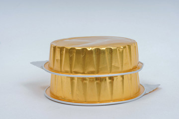 Canned pate on a white background. Canned food in gold packaging. Foil packaging for pate