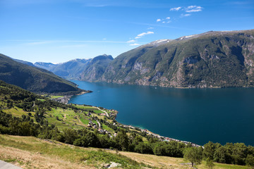 Fototapeta na wymiar Aurlandsfjord fjord in Sogn og Fjordane county with mountain village Aurlandsvangen. Norway. Seen from route E16 and Stegastein viewpoint