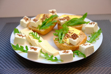 Fresh bread with cheese and basil for breakfast in a trip