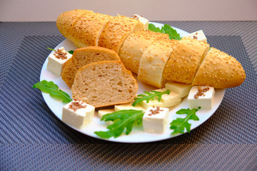 Fresh bread with cheese and basil for breakfast in a trip