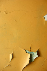 old dirty wall with yellow paint cracked from time to time, can be used as a background or texture